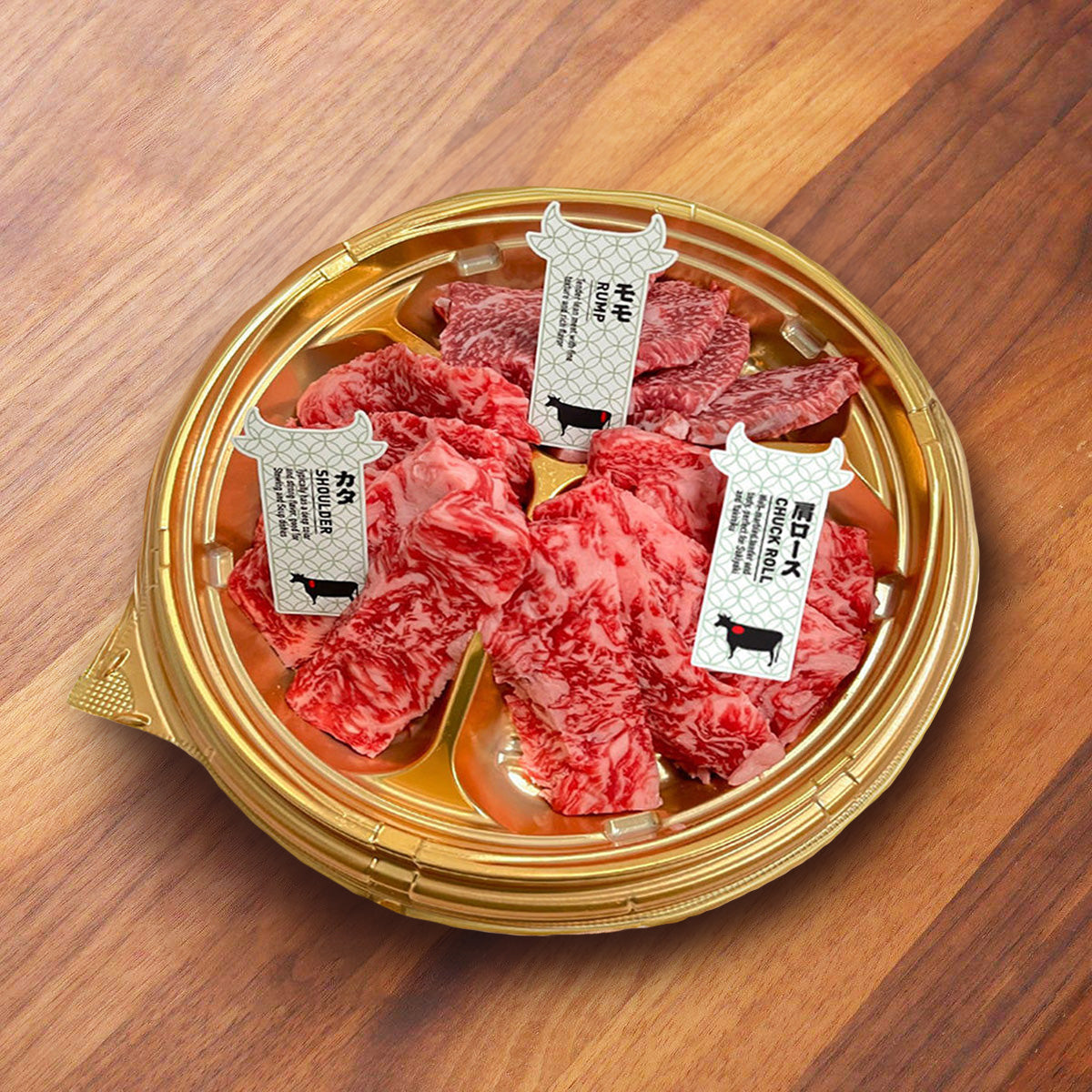Chilled A5 wagyu yakiniku set on gold tray with labeled beef cuts
