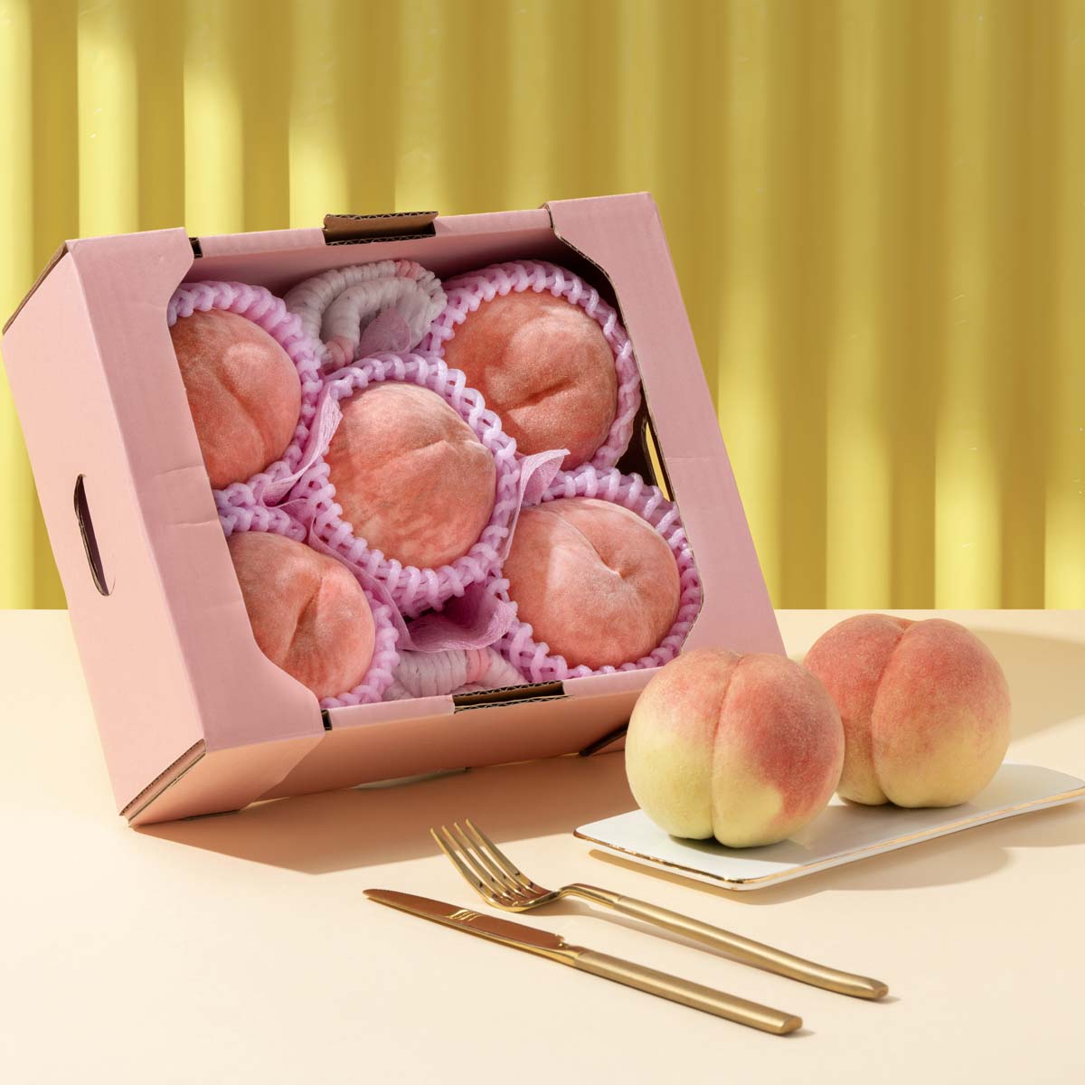 Japanese peach tasting box with open lid, assorted pink peach pieces in paper tray