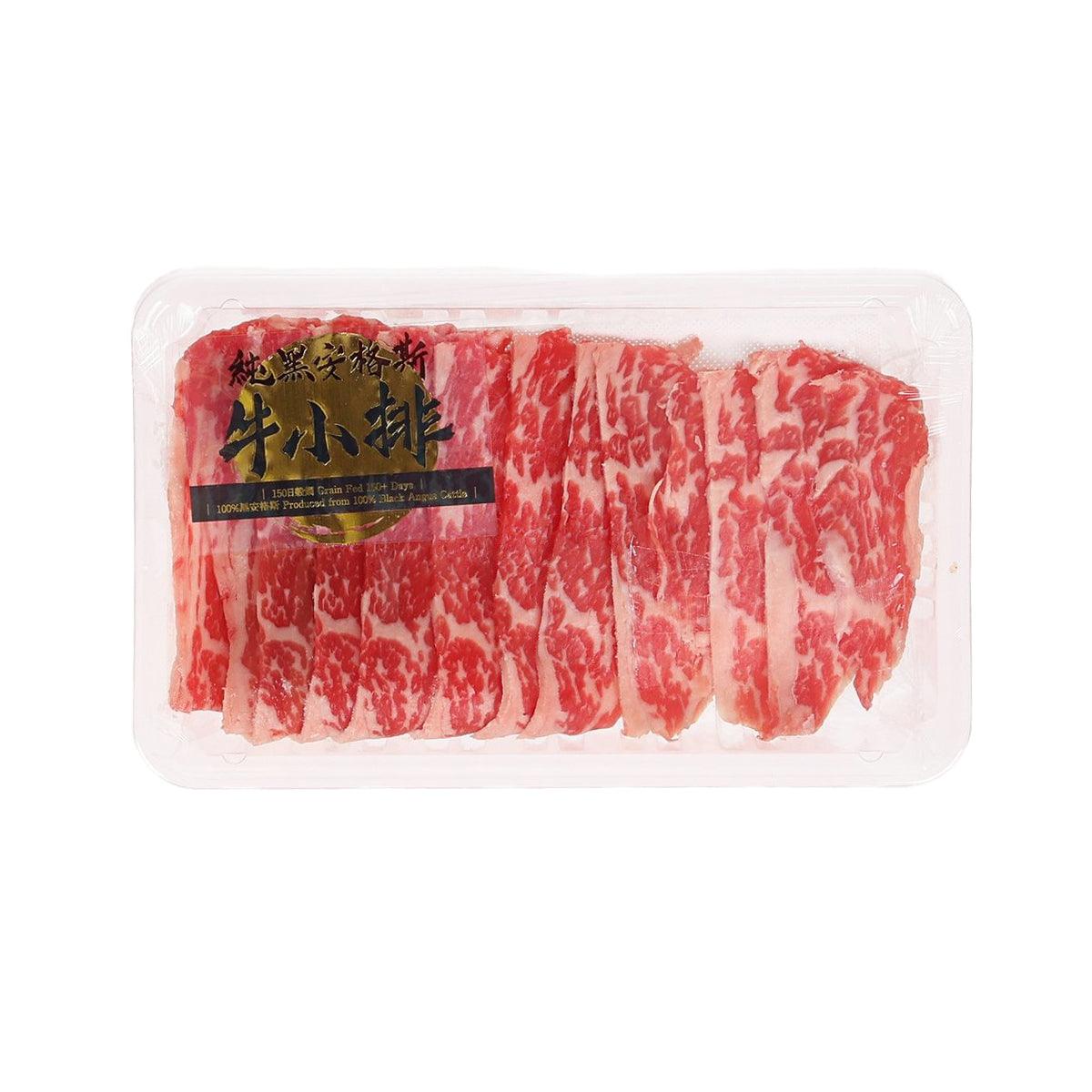 Beef short rib slices in clear plastic tray, red and white marbled stripes