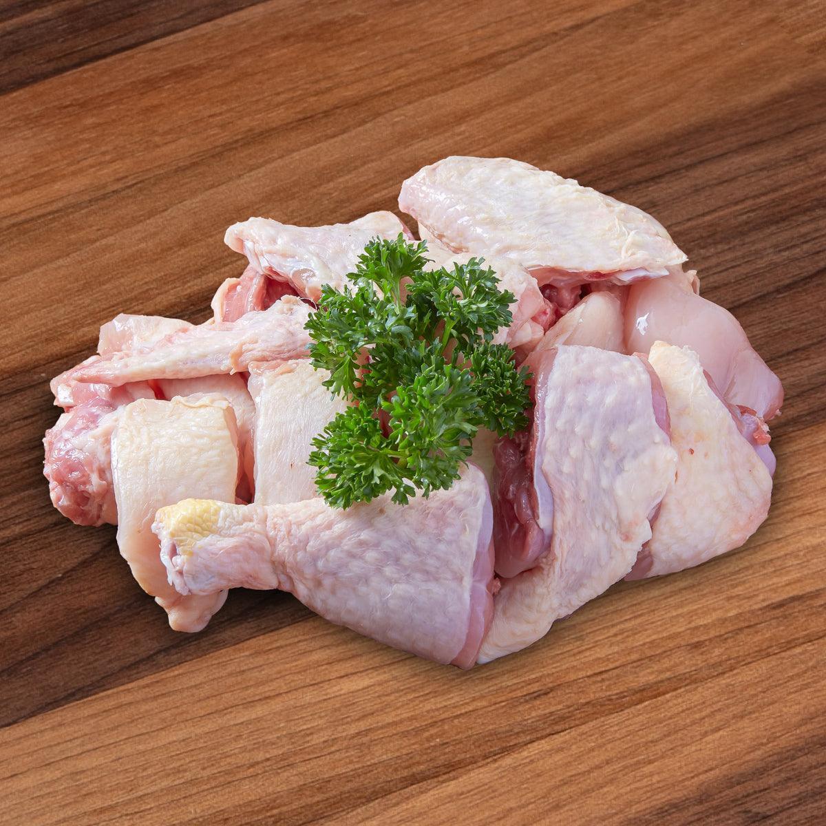Raw chicken pieces for steaming with fresh parsley garnish
