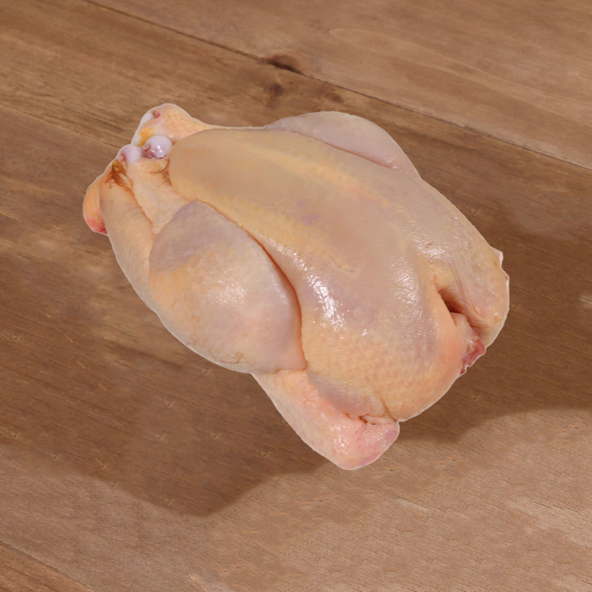 Frozen whole spring chicken, pale pink skin, ready-to-cook form