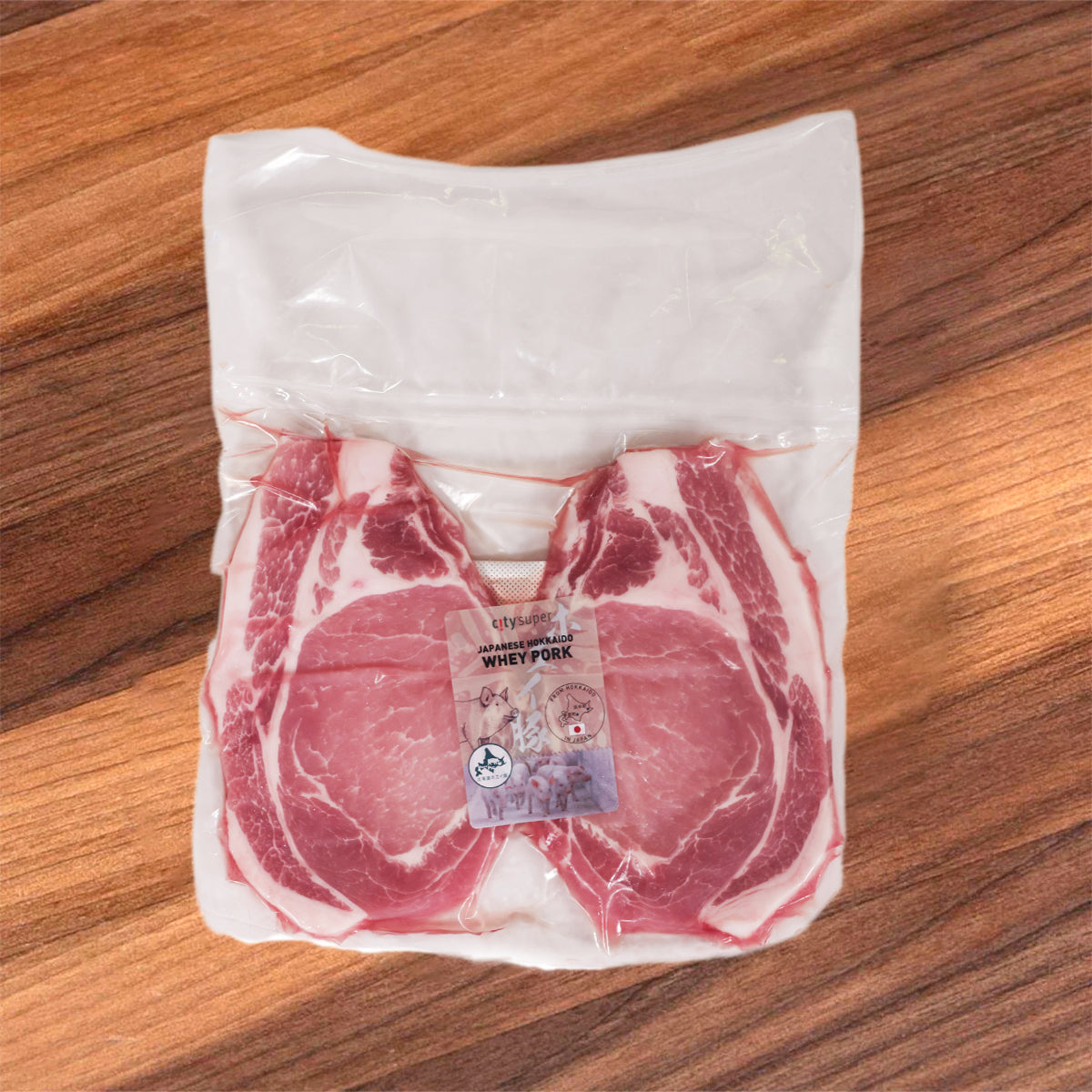 Frozen pork loin in sealed bag, marbled pink and white meat