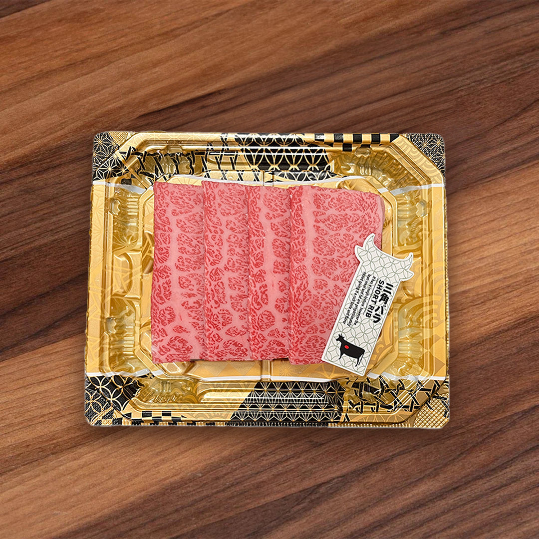 Chilled A5 wagyu yakiniku set in gold foil tray with pink marbled beef cuts