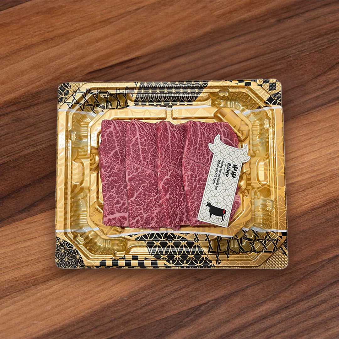 Pack of marbled red wagyu beef yakiniku slices in gold foil tray with label