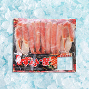 Boiled snow crab legs in vacuum-sealed pack, visible red crab meat