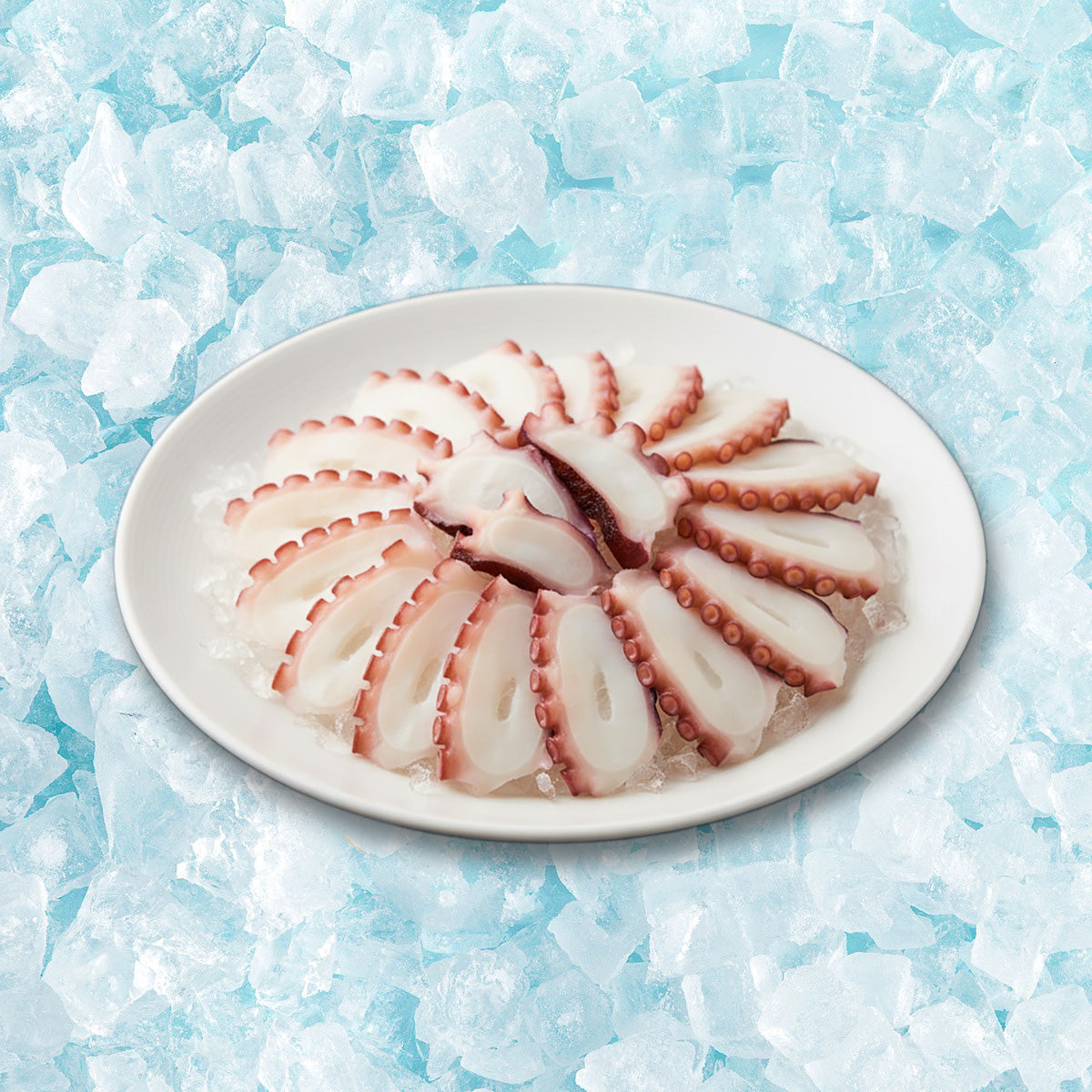 Sliced octopus shabu-shabu on a white oval plate, light pink seafood pieces