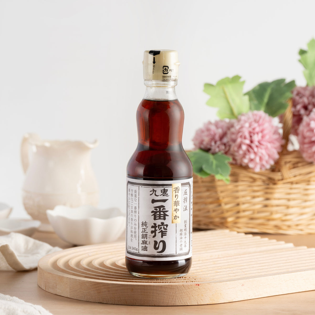 KUKI pure sesame oil bottle, amber glass, screw-cap, front label, angled view