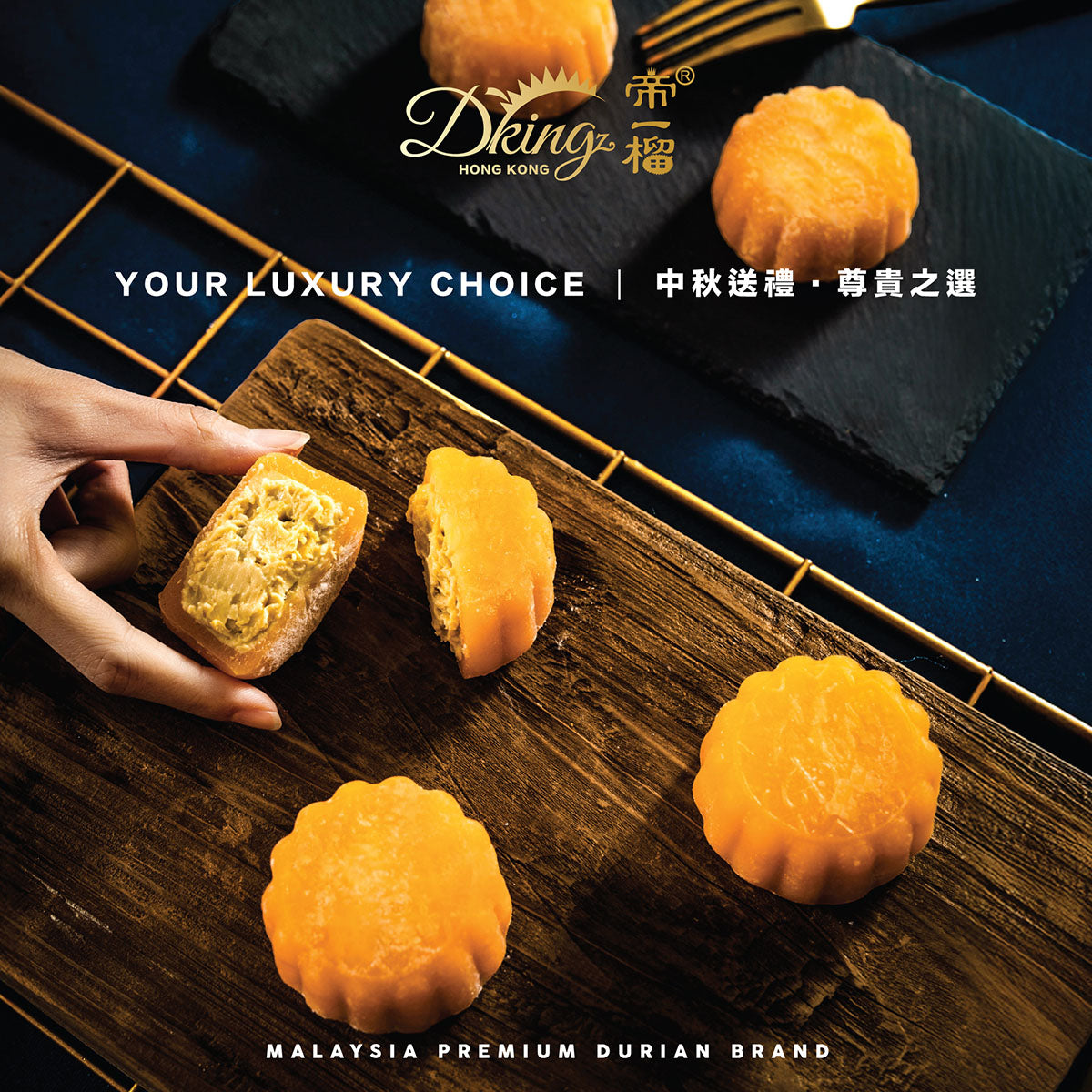 Durian mooncakes on dark slate with sliced pieces and hand holding a piece