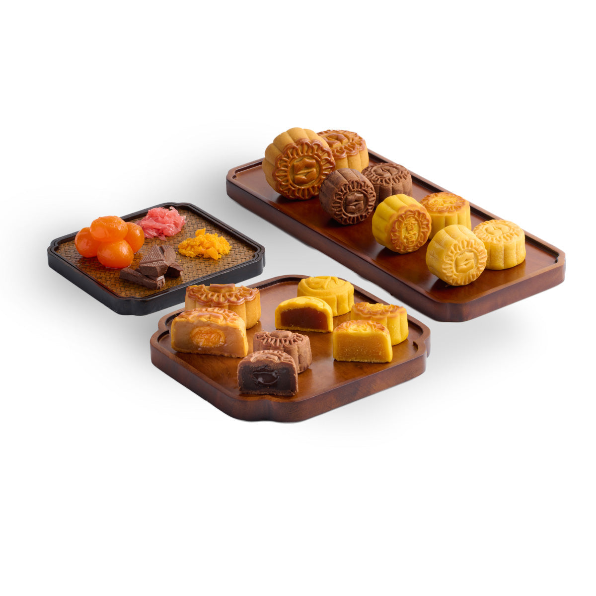Assorted mooncakes on three serving boards, with custard, chocolate, and lotus shapes