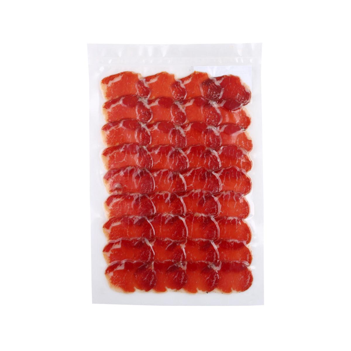 Cured pork loin slices, red, in a clear vacuum-sealed plastic pack