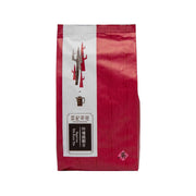 Red packaged tea pouch with front label and brand emblem