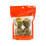 Snack bag with four dark green-brown dried round pieces