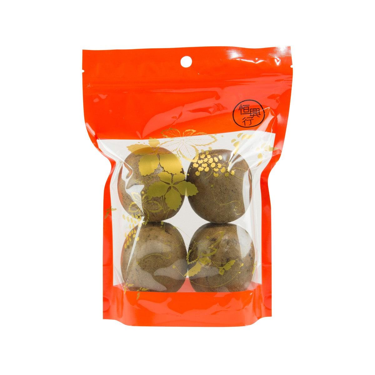 Snack bag with four dark green-brown dried round pieces