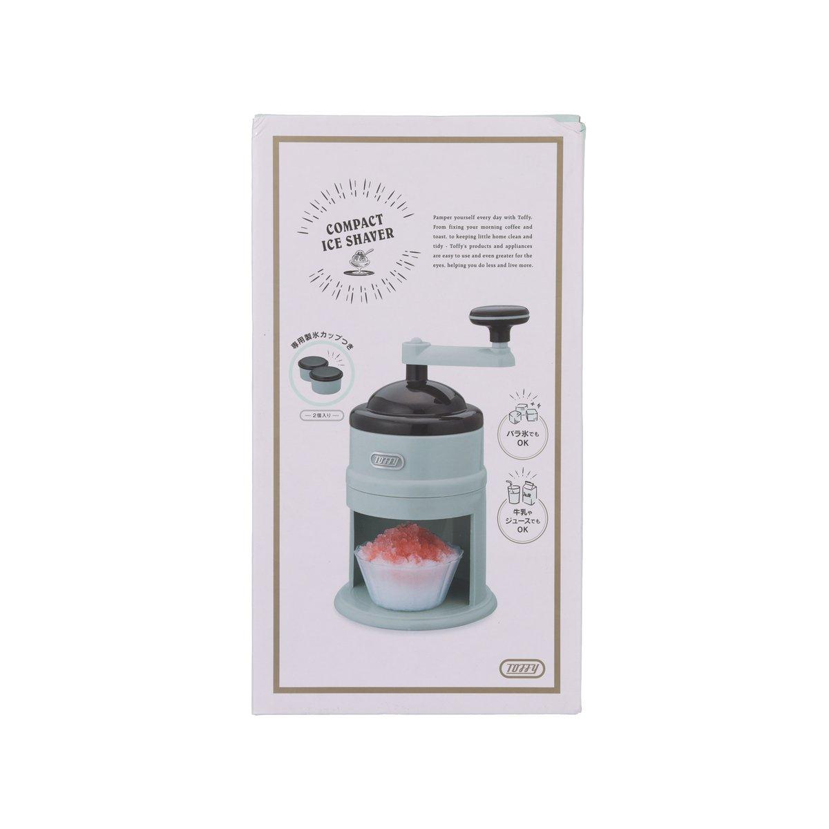 Compact ice shaver with pale aqua base and black hand crank, for countertop use