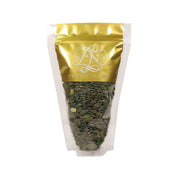 FRUTTI NUTTI pumpkin seeds pouch with gold top and green seeds inside