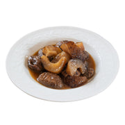 Cooked sea cucumber mushroom pieces in brown sauce on a plate