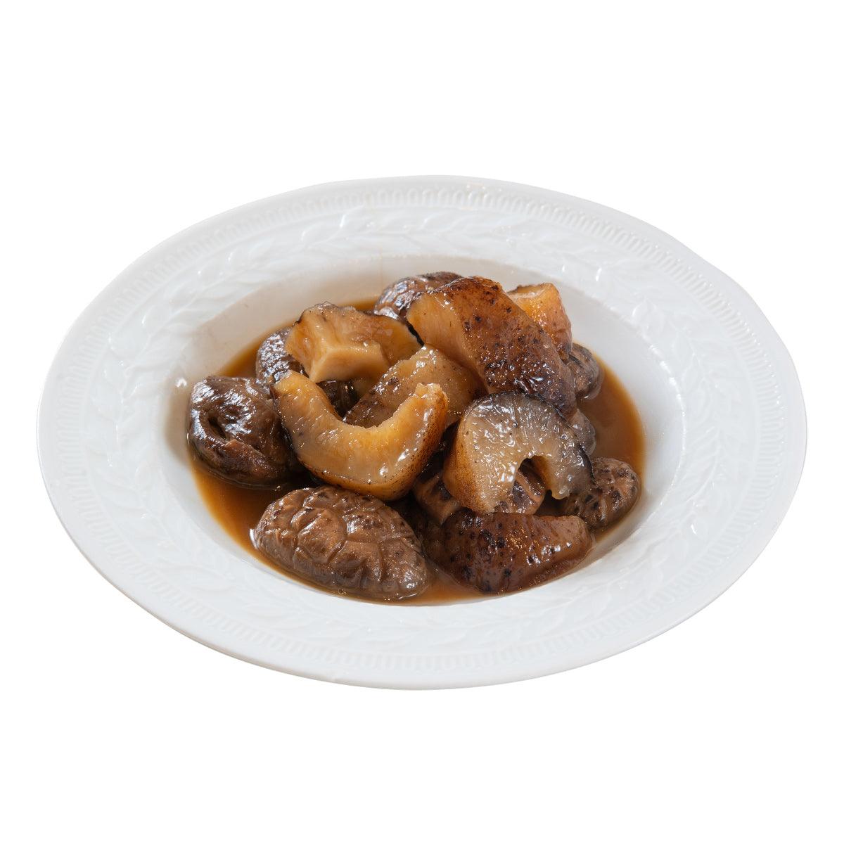 Cooked sea cucumber mushroom pieces in brown sauce on a plate