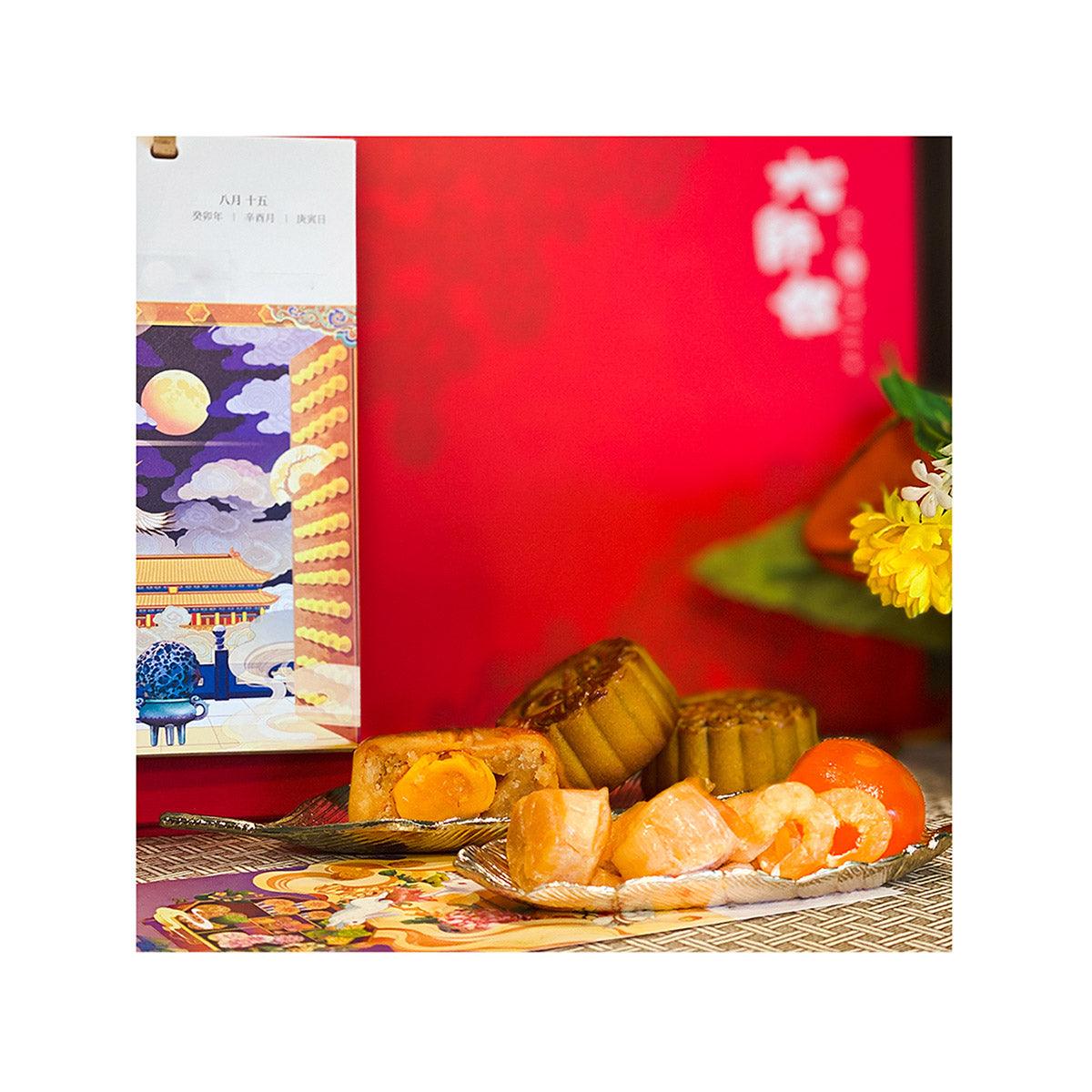 Mooncake gift set with red packaging and assorted pastries on tray
