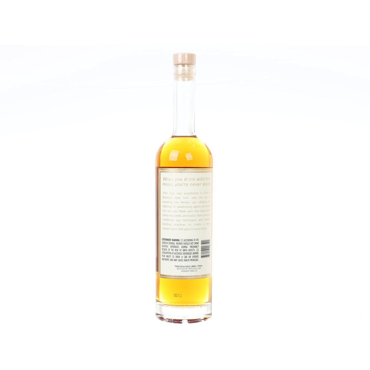 Soju bottle with clear glass and amber liquid, back label with printed text.