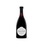 Wine bottle with dark glass, black cap, and round label
