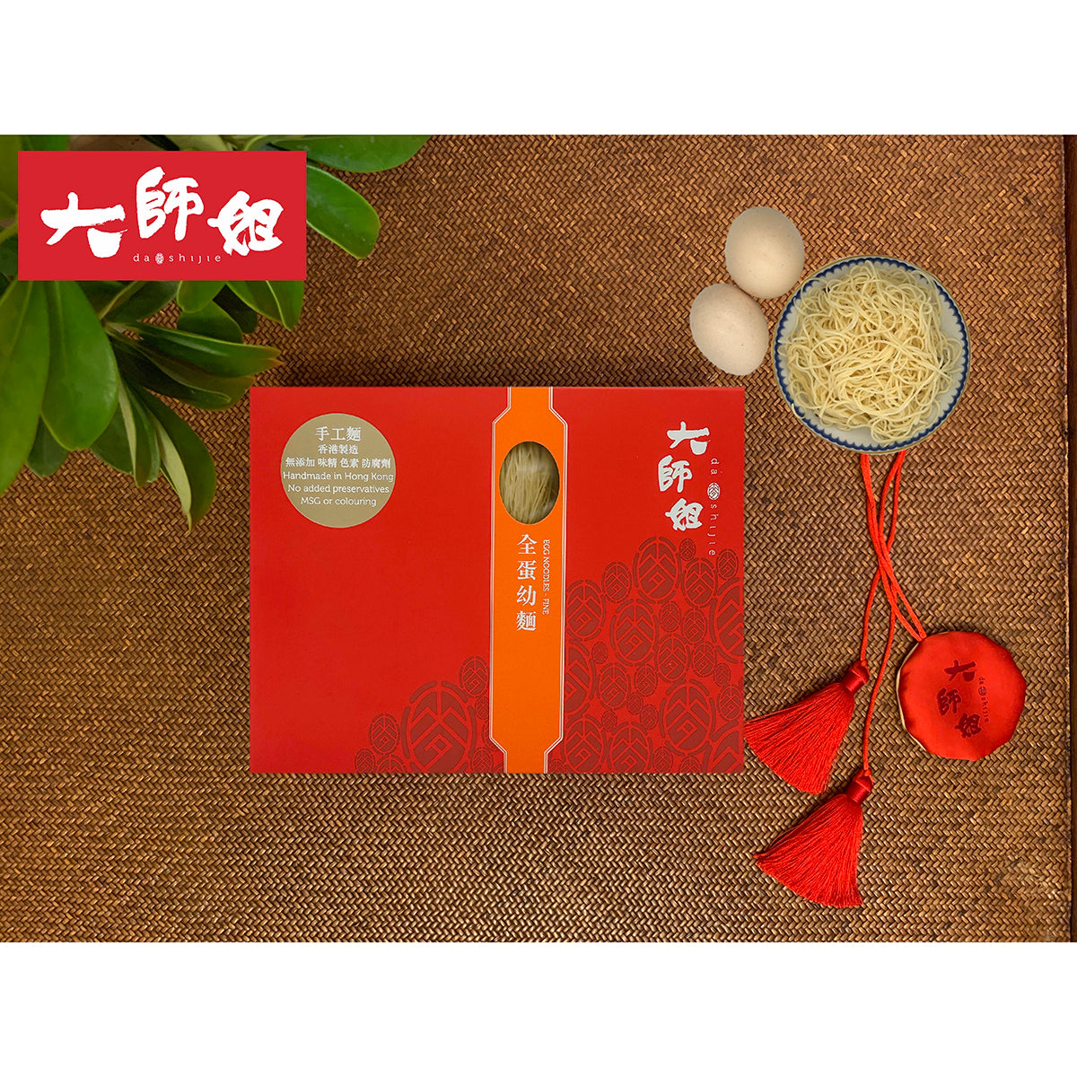 Egg noodle bundle with red gift package, bowl of fine yellow noodles and whole eggs