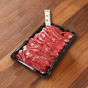 Sliced rib beef in black hot pot tray, ready for cooking