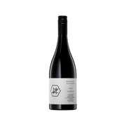 Wine bottle with black capsule and white label, dark glass