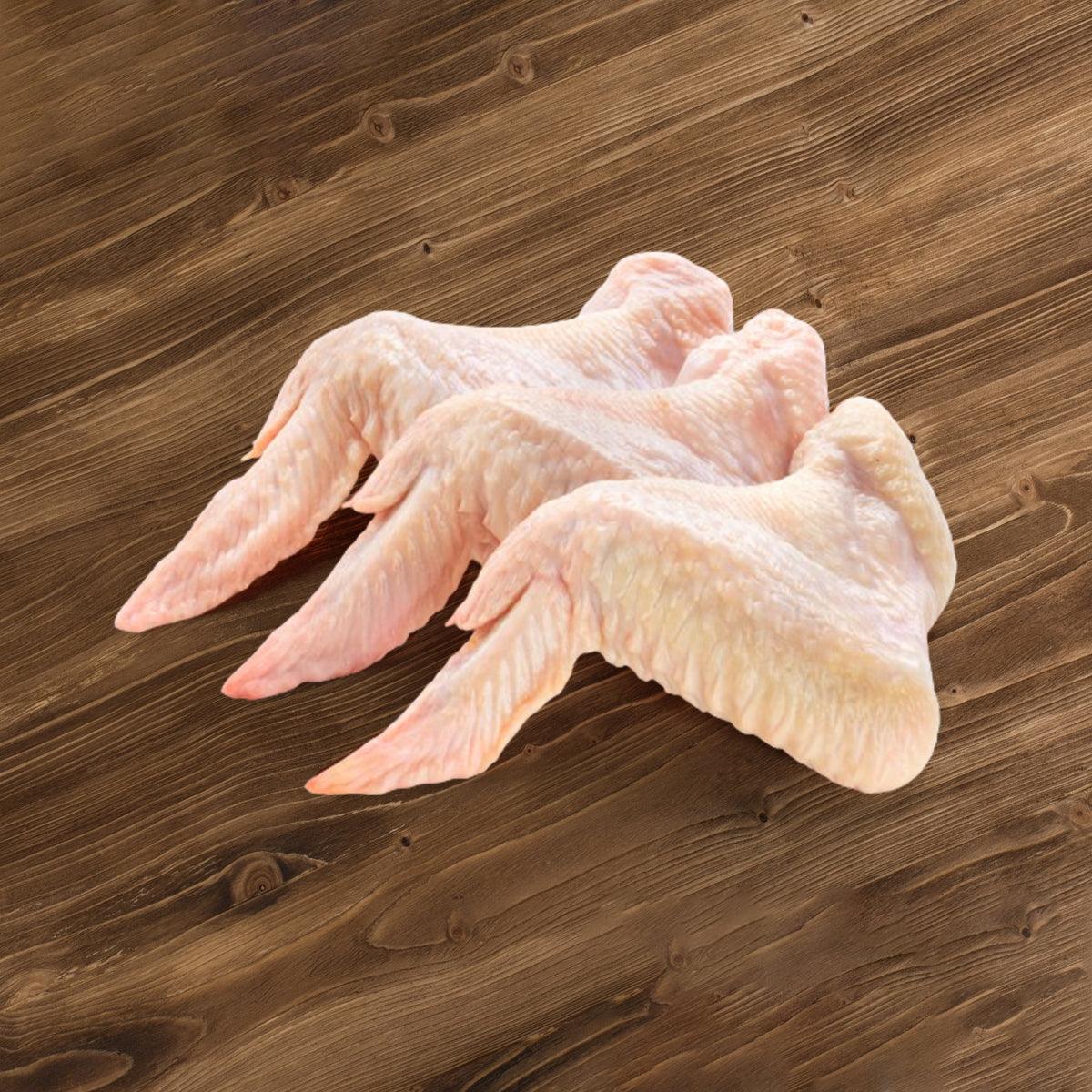 Frozen chicken wing sections, pale pink, ready for skewer preparation