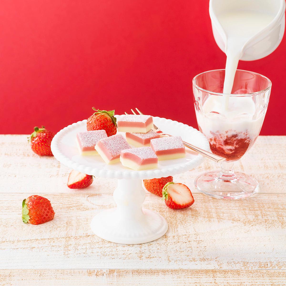 Strawberry milk nama chocolate squares with strawberries and milk being poured