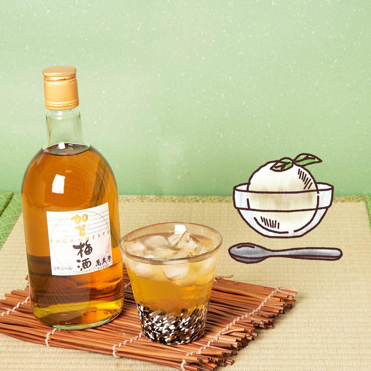Kaga umeshu bottle with amber drink in glass and bamboo coaster