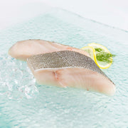 Black cod slice, raw-looking fillet with skin, in a single piece