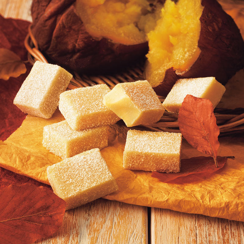 Square roasted sweet potato Nama chocolate pieces on parchment with leaves